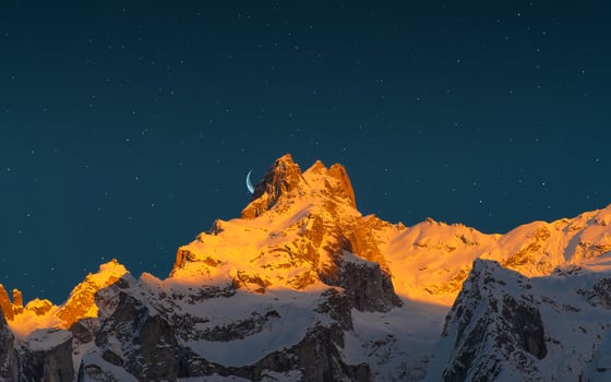 Last sun of the mountains with the moon and the stars photo