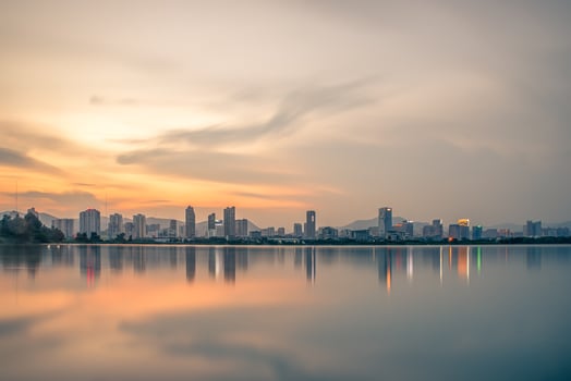 At dusk, the lake reflects the night view of the city photo