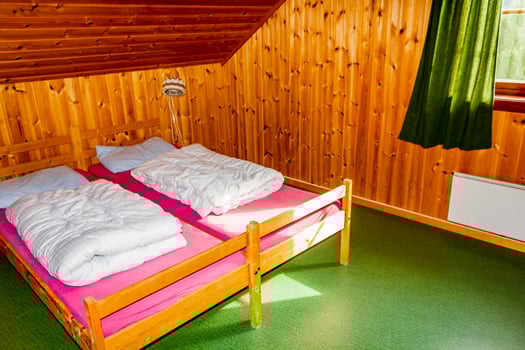 Cottage vacation interior decoration. Bedroom with beds in Norway photo