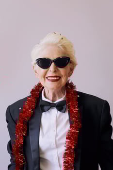 Beautiful stylish mature senior woman in sunglasses and tuxedo celebrating new year. Fun, party, style, celebration concept photo