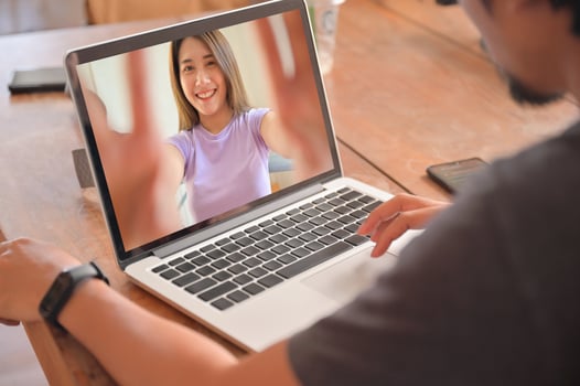 Young men using laptop are chatting online with female friends. photo