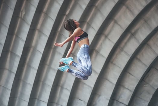 Woman doing parkour in the city on a sunny day. photo