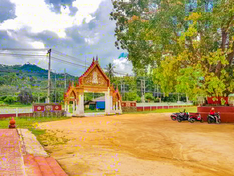 Colorful architecture of entrance gate Wat Ratchathammaram temple Thailand photo