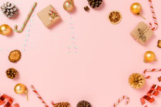 Minimal creative flat lay of christmas traditional composition and new year holiday season. Top view winter christmas decorations on pink background with blank space for text. Copy space photography. photo