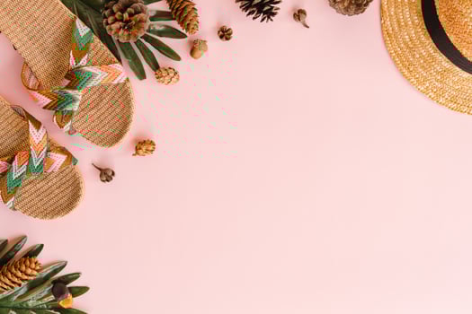 Creative flat lay photo of travel vacation spring or summer tropical fashion. Top view beach accessories on pastel pink color background with blank space for text. Top view copy space photography.