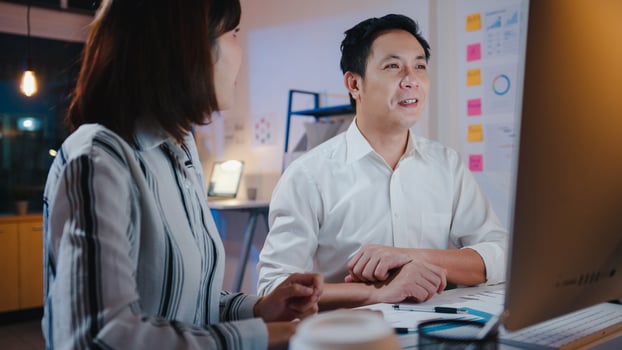Group of Asia businessman and businesswoman using computer presentation and communication meeting brainstorming ideas about new project colleagues working plan success strategy in night home office. photo