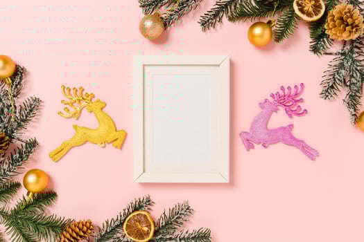 Minimal creative flat lay of winter christmas traditional composition and new year holiday season. Top view mockup black picture frames for text on pink background. Mock up and copy space photography. photo
