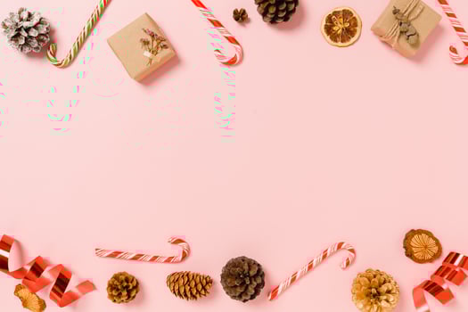 Minimal creative flat lay of christmas traditional composition and new year holiday season. Top view winter christmas decorations on pink background with blank space for text. Copy space photography. photo