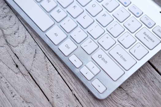 close up keyboard on wooden table and business concept photo