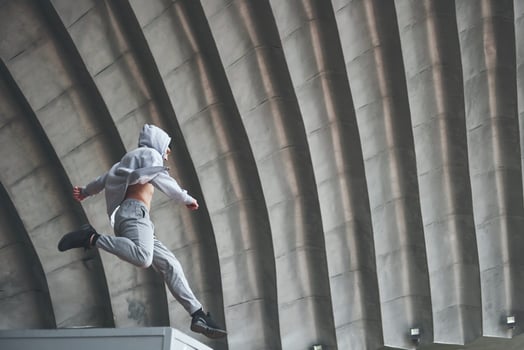 The man outdoors practices parkour, extreme acrobatics. photo