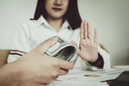 focus hand holding money, The auditor shows a gesture of refusing to receive money from the bribery of the officer. photo