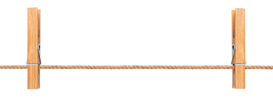 Wooden clothespins on rope isolated on white background photo