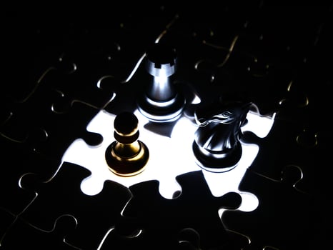 Gold and silver chess piece on jigsaw puzzle background, business concept photo
