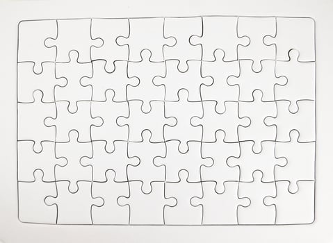White jigsaw puzzle pieces completed as copy space photo