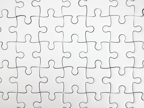 White jigsaw puzzle pieces completed as copy space photo