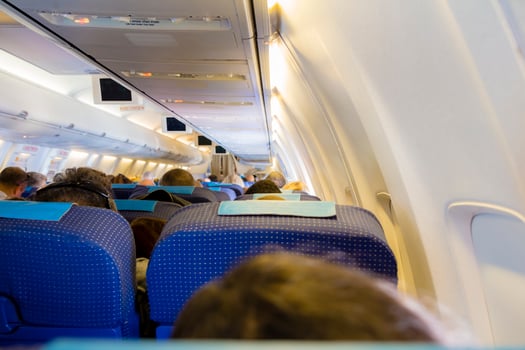 Interior of passenger airplane with people on seats photo