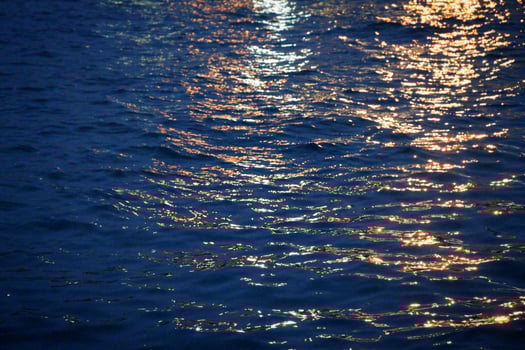 Beams of light on water during twilight photo