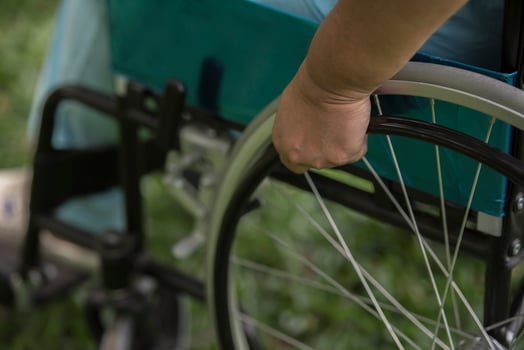 Close up Lonely elderly woman sitting on wheelchair at garden in hospital photo