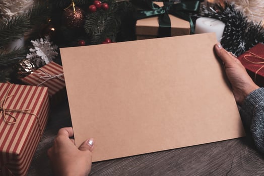 Christmas holiday greeting paper design mockup with decoration on wood table. photo