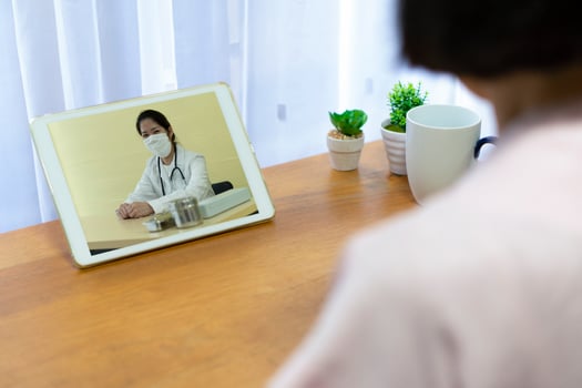 senior patient who got fever and cough consult asian doctor about medication via video call. telemedicine and new normal lifestyle concept photo