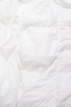 Top view of bedding sheets crease, white blanket texture. Close up of bedding sheets with copy-space photo