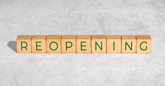 Reopening concept after the coronavirus pandemic. Wooden blocks with text isolated on concrete background photo