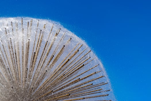 Dandelion fountain close up on blue sky background photo