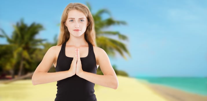 Young beautiful sporty woman doing yoga exercise on sea wooden beach near water. Girl practicing exercises mudra. Hands in namaste. Gratitude sign. Health summer concept photo