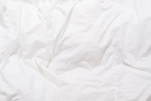 Top view of bedding sheets crease, white blanket texture. Close up of bedding sheets with copy-space photo