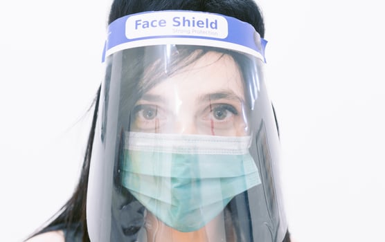 woman nurse with face mask and face shield photo