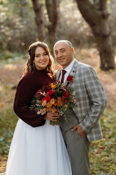 walk of the bride and groom through the autumn forest photo