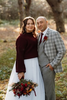 walk of the bride and groom through the autumn forest photo