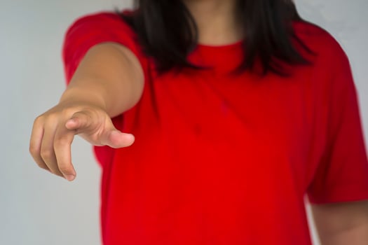 A beautiful young girl pinting with her index finger photo