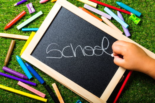 top view, school accessories on green grass. Back to school concept photo