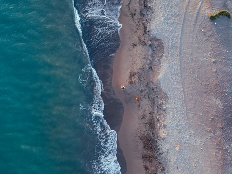 Aerial views of a girl with her dog at a virgin beach, in Natural park Punta Entinas, Almeria, Spain photo