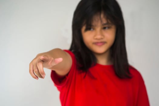 A beautiful young girl pinting with her index finger photo
