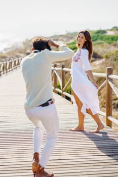 Man photographing his girlfriend on a lovers' trip. photo