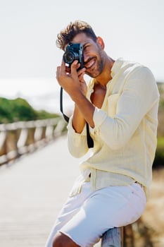 Handsome man photographing in a coastal area. photo