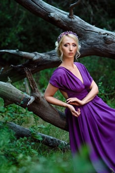 Girl model blonde in a lilac dress with a bouquet photo