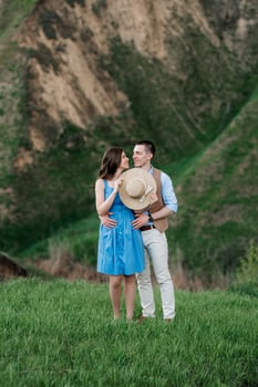 young couple a guy and a girl are walking in the mountain hills photo