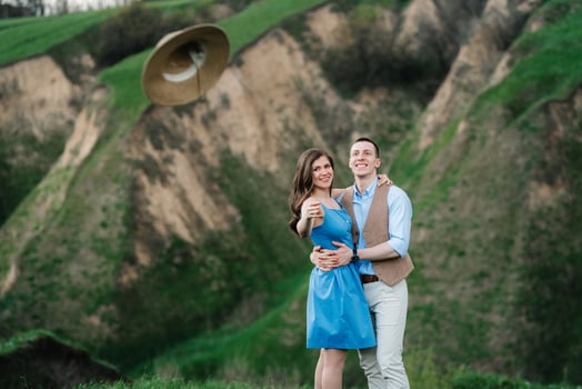young couple a guy and a girl are walking in the mountain hills photo