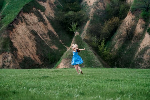 young couple a guy and a girl are walking in the mountain hills photo