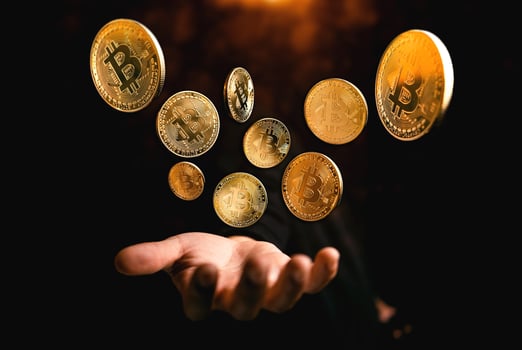 golden bitcoin coin on hand on dark background photo