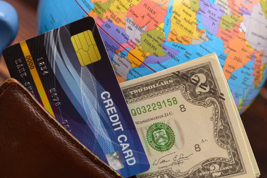 A credit card and a wallet sitting on a table photo
