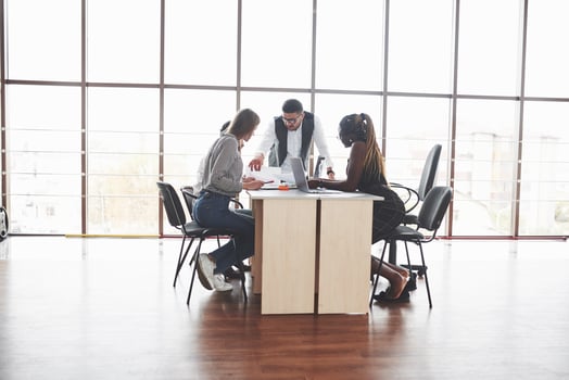Group of freelancers working in the spacious office with big windows photo