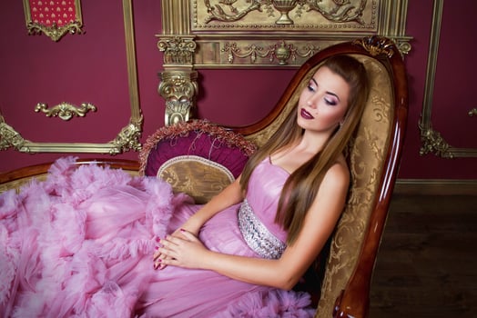portrait of young beautiful woman in long pink dress photo