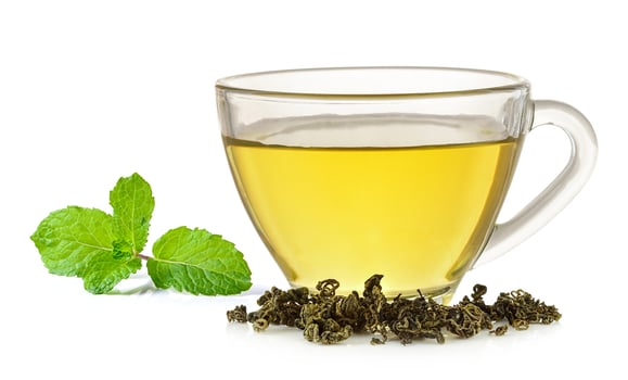 Glass cup of  green tea and mint isolated on white background photo