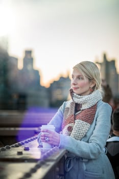 Woman on the Brooklyn Bridge Looking at Manhattan with a Coffee photo