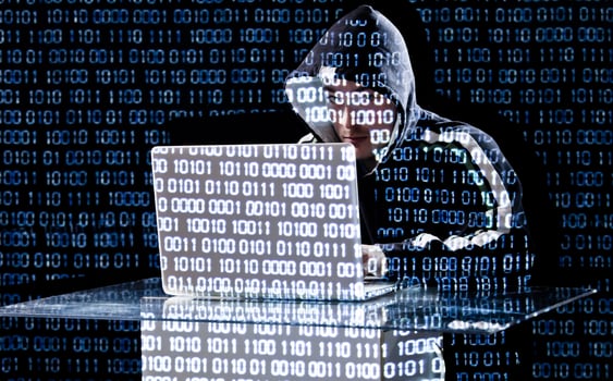 Hacker typing on a laptop photo