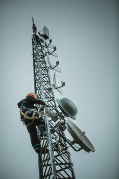 Telecom Worker Climbing Antenna Tower photo